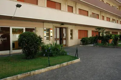 a building with a parking lot in front of it at La Lanterna Di San Pietro in Rome