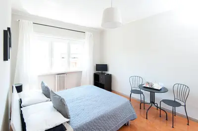 a bedroom with a bed and a table and chairs at La Lanterna Di San Pietro in Rome