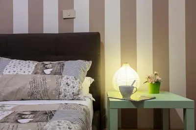 a bedroom with a bed and a table with a lamp at Liberty House in Rome