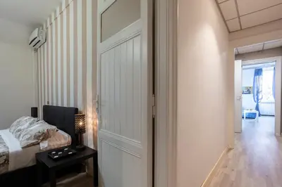 a bedroom with a door and a bed and a table at Liberty House in Rome