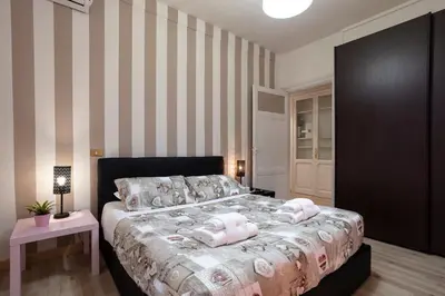a bedroom with a bed with pink towels on it at Liberty House in Rome
