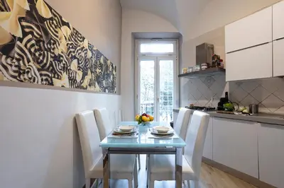 a kitchen with a blue table and chairs in a room at Liberty House in Rome