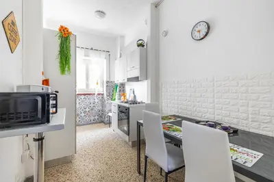 a kitchen with a table and chairs and a microwave at Dreamhome61 by Rentbeat in Rome