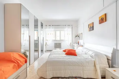a bedroom with a large bed and a mirror at Dreamhome61 by Rentbeat in Rome