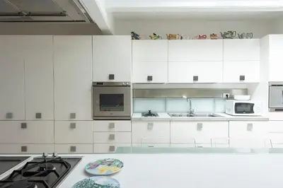 a white kitchen with white cabinets and a stove at The Great Beauty in Rome