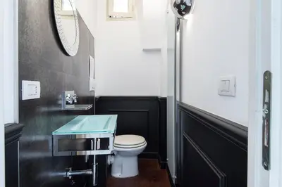 a bathroom with a toilet and a sink and a mirror at The Great Beauty in Rome