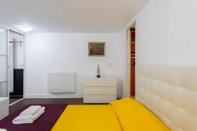 a bedroom with a yellow bed and a radiator at The Great Beauty in Rome