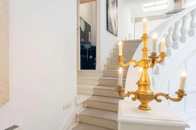 a chandelier with candles on a staircase at The Great Beauty in Rome
