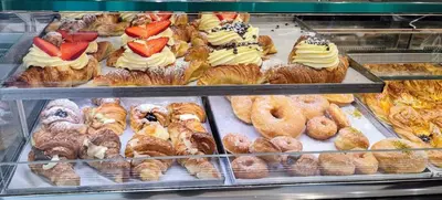 a display case in a bakery filled with lots of pastries at Miracol in Rome
