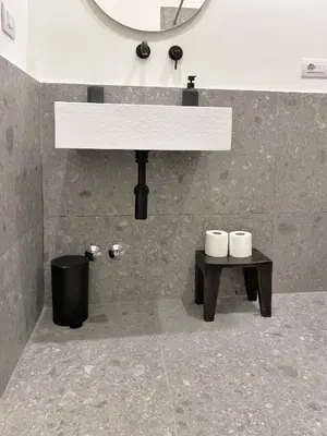 a bathroom with a sink and a table with two toilets at Boutique Via Veneto Apartment by SupaStays in Rome