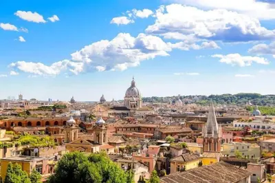 a view of a city with a blue sky and clouds at Under Trastevere stars in Rome