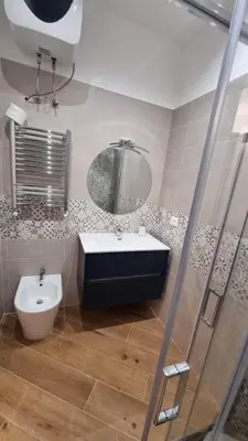 a bathroom with a sink and a toilet and a mirror at Under Trastevere stars in Rome