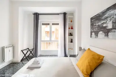 a white bed in a room with a window at That's amoR in Rome