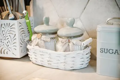 two glass jars in a basket on a counter at Appia Antica Country House giardino parcheggio Fermata bus in Rome