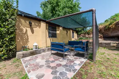 a patio with blue chairs and a gazebo at Appia Antica Country House giardino parcheggio Fermata bus in Rome