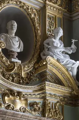 a gold frame with a statue in front of a mirror at Palazzo Shedir - The Leading Hotels of the World in Rome