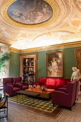 a living room with a red couch and a ceiling at Palazzo Shedir - The Leading Hotels of the World in Rome