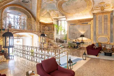 a large room with a staircase in a building at Palazzo Shedir - The Leading Hotels of the World in Rome