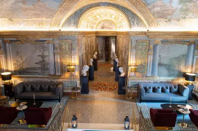 a lobby with couches and paintings on the walls at Palazzo Shedir - The Leading Hotels of the World in Rome