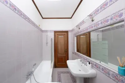 a bathroom with a sink and a mirror at [10 min Vaticano] Big home Balduina con piscina in Rome