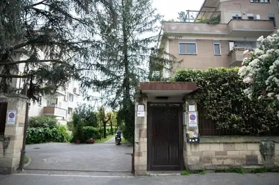 a building with a gate in front of a street at [10 min Vaticano] Big home Balduina con piscina in Rome