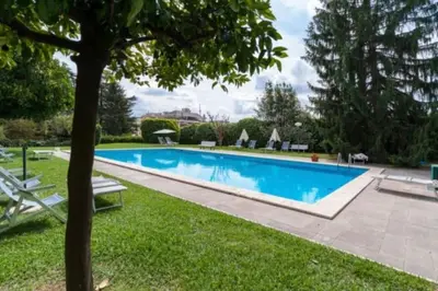 a swimming pool in the yard of a house at [10 min Vaticano] Big home Balduina con piscina in Rome