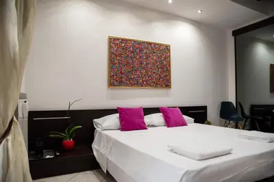 a bedroom with a large white bed with pink pillows at Boschetto49 in Rome