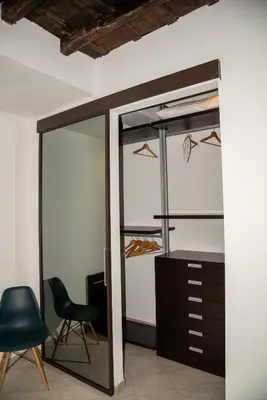 a room with a closet with a chair and a desk at Boschetto49 in Rome