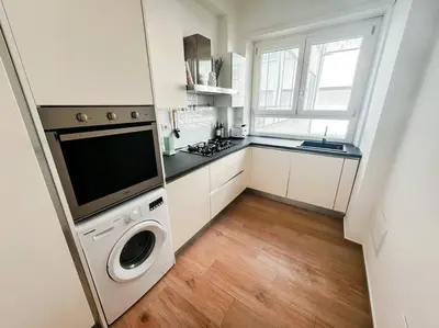 a kitchen with a washer and dryer in a room at ophelia apartment in Rome