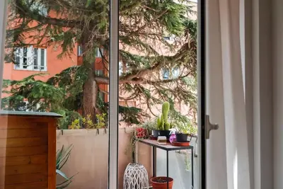 a sliding glass door with plants on a table outside at ophelia apartment in Rome
