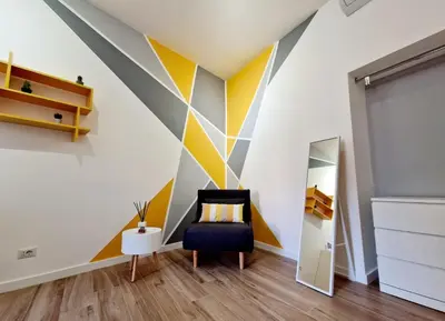 a room with a striped wall with a chair and a mirror at Varia Domus in Rome