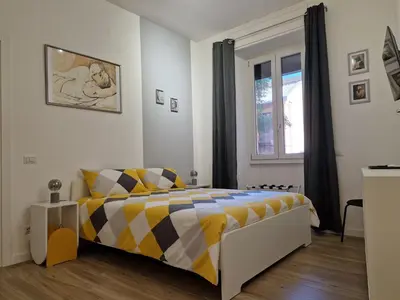 a bedroom with a bed and a window at Varia Domus in Rome