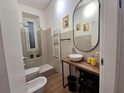 a bathroom with two sinks and a large mirror at Varia Domus in Rome
