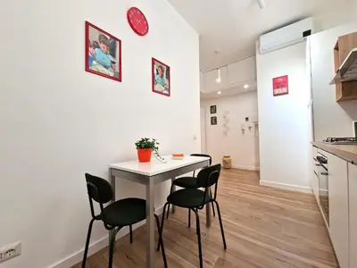 a kitchen and dining room with a table and chairs at Varia Domus in Rome