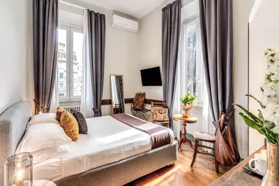 a bedroom with a bed and a living room at Tree Charme Trilussa in Rome