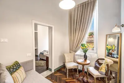 a living room with a couch and a table at Tree Charme Trilussa in Rome