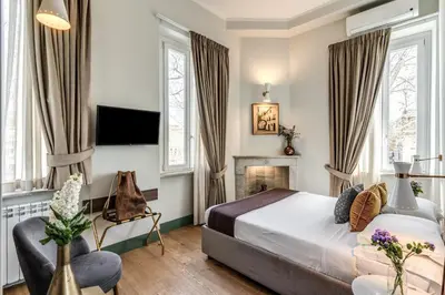 a bedroom with a bed and a fireplace at Tree Charme Trilussa in Rome
