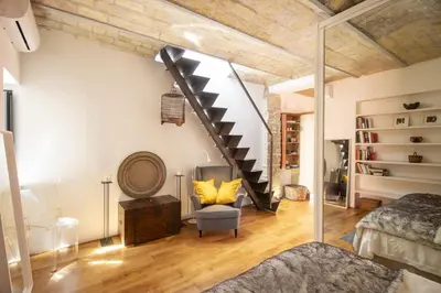 a loft conversion with a staircase and a bedroom at Scuderie San Lorenzo in Rome