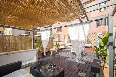 an outdoor patio with white drapes at Scuderie San Lorenzo in Rome