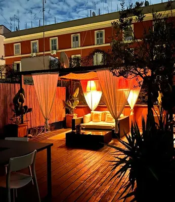 a patio with a couch and a table and a building at Scuderie San Lorenzo in Rome