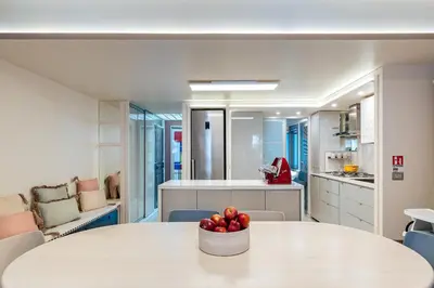 a room with a table with a bowl of fruit on it at Altiora - Luxury loft in Trastevere, Rome in Rome
