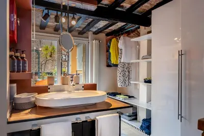 a bathroom with a large sink and a mirror at Altiora - Luxury loft in Trastevere, Rome in Rome