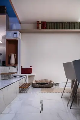 a kitchen with white walls and white floors at Altiora - Luxury loft in Trastevere, Rome in Rome