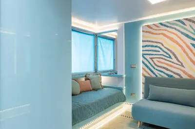 a bedroom with a bed and a window and a couch at Altiora - Luxury loft in Trastevere, Rome in Rome