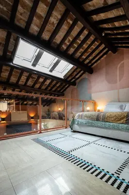 a bedroom with a bed and a large window at Altiora - Luxury loft in Trastevere, Rome in Rome