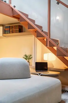 a bedroom with a bed and a desk with a laptop at Altiora - Luxury loft in Trastevere, Rome in Rome