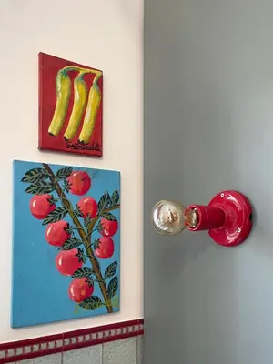a door with a painting of fruit on the wall at Casetta Roma San Giovanni in Rome