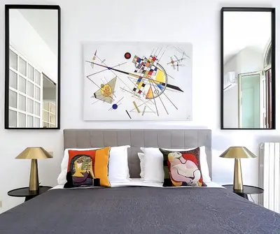a bedroom with a bed with three pictures on the wall at Trevi over the top apartment in Rome