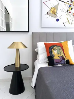 a bedroom with a bed with a lamp and a table at Trevi over the top apartment in Rome