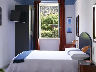 a bedroom with a bed and a window at Bivio - Casa Azzurra in Rome
